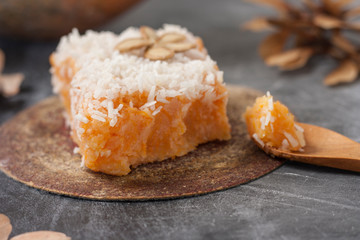 Slice of fresh homemade pumpkin pie and semolina on a black background. . A Thanksgiving or holiday treat. Traditional autumn dish. Close up