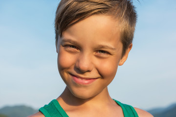 Closeup portrait of a boy in beauty summer day.