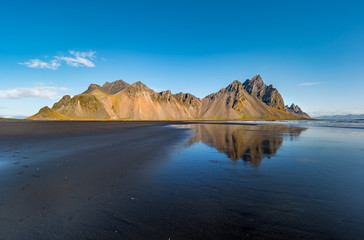 Epic view landscape of the black sand beach in Stokksnes on a sunny day. Vestrahorn mountain in the background. Nature and ecology concept background.