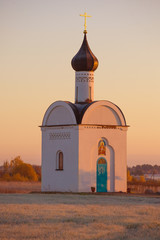 The old Chapel of the Sovereign Icon of the Mother of God close-up in October dawn. The surroundings of Izborsk. Pskov region, Russia