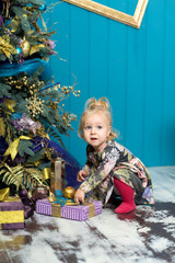 Happy little smiling girl with christmas gift box.