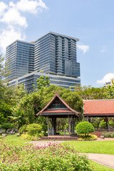 modern tall apartment complex and traditional idyllic park
