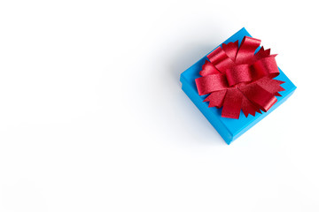 Blue gift box with red ribbon on white clear background, Top view.