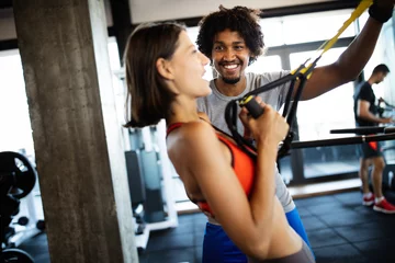 Deurstickers Young beautiful woman doing exercises with personal trainer © NDABCREATIVITY