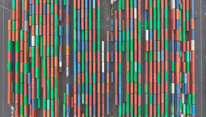 TOP DOWN Flying high above long rows of colorful shipping containers in LA docks