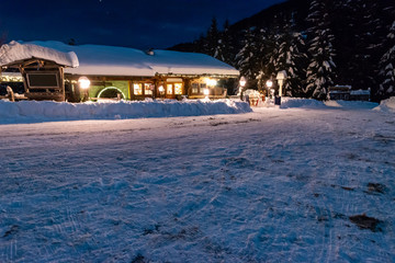 restaurant in the alps covered with snow at night