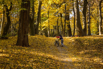 child walking in park in autumn