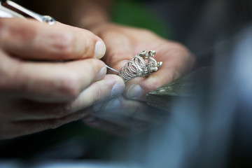 jeweller handmade work, crafting golden ring with tools, closeup