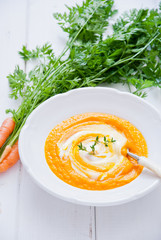 Creamy Carrot Soup on a white wooden background