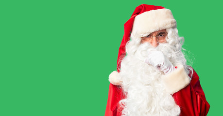 Middle age handsome man wearing Santa Claus costume and beard standing feeling unwell and coughing as symptom for cold or bronchitis. Healthcare concept.