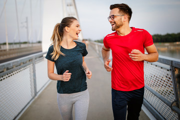 Fitness, sport, people, exercising and lifestyle concept. Couple running outdoor