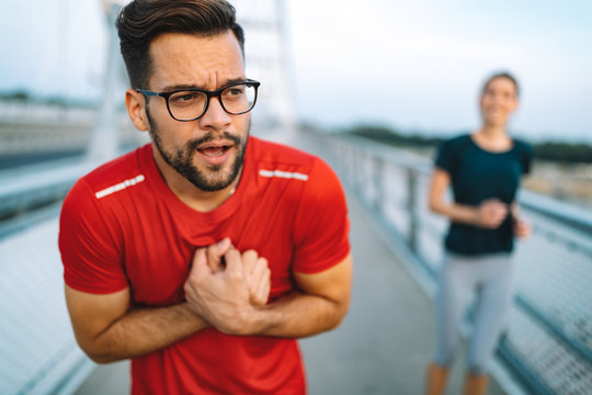 Man feeling pain in heart during exercise outdoor