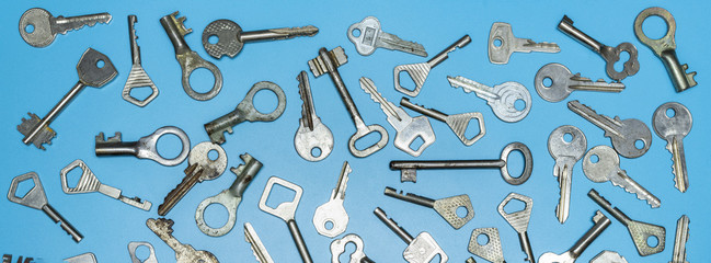 Keys set on blue background. Door lock keys and safes for property security and house protection....