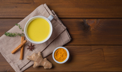 Golden milk with turmeric and cinammon. Diet, healthy, and detox drink. Trendy drink. Top view