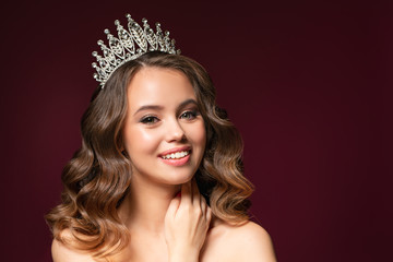 Beautiful portrait of young woman with perfect make-up, hairstyle, and nail design. Beauty contest. Crown on her head © Ксения Левашова