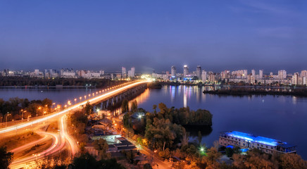 Fototapeta na wymiar KYIV, UKRAINE – 14 OCTOBER 2019:The night landscape of Paton bridge and left bank of Kyiv