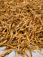 Set of freshly harvested bean pods piled on a white cloth for drying