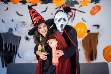 happy couple of love  in costumes and makeup on a celebration of Halloween