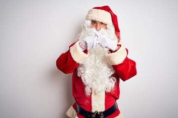 Middle age handsome man wearing Santa costume standing over isolated white background Rejection expression crossing fingers doing negative sign