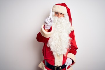 Middle age handsome man wearing Santa costume standing over isolated white background Pointing with finger up and angry expression, showing no gesture