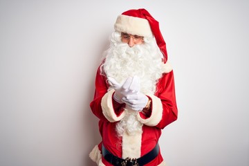 Middle age handsome man wearing Santa costume standing over isolated white background Suffering pain on hands and fingers, arthritis inflammation