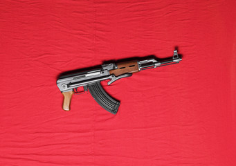 Kalashnikov assault rifle AK-47 on a red background