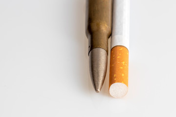 Smoking kills. Cigarette and deadly bullet.
