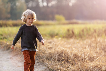 Cute little boy outdoor in the fields 