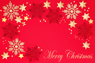 Merry Christmas background border with snowflake and star bauble decorations on red background with copy space. Traditional Christmas card concept for the holiday season.