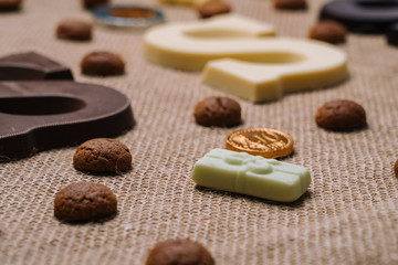 Dutch holiday Sinterklaas.Burlap sack and traditional food - pepernoten, chocolate letter, sweets strooigoed and carrots for horse. Concept for children party in Saint Nicolas day five december.