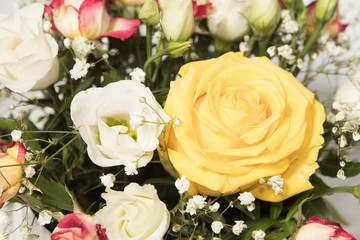 beautiful delicate floral bouquet with yellow pink shades on the background