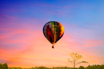 Multi color balloon in the  sky sun set wuth forest in the down