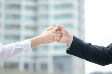 Business man and business woman of a Partnership Team Giving Fist Bump after complete deal