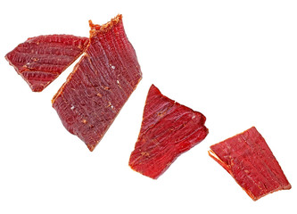 Beef jerky pieces on a white background, top view.
