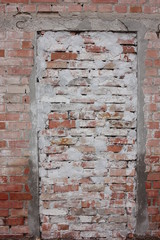 Blocked up a doorway or entryway in a red and white brick wall. Bricked up door. No exit	