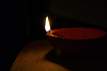 handmade Diwali diya and flame