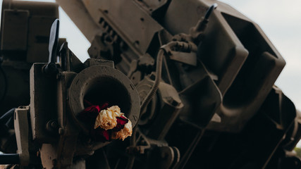 flowers placed inside the anti-aircraft defensive cannon located as a reminder of the historical facts of humanity