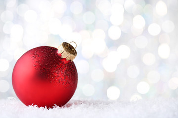 Christmas bauble with white snow on blurred background