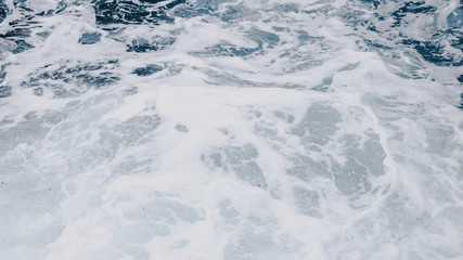 Texture of sea water with foam produced in a wave