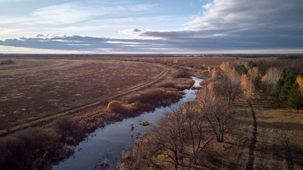 View of the autumn forest river from the air