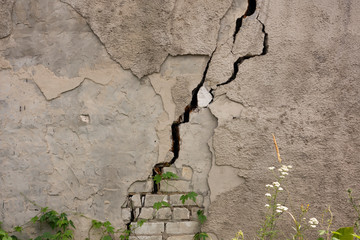 Damaged house dilapidated old building wall. Private abandoned home fall to ruin. Sunny day,...