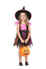 Young girl in halloween costume holding pumpkin bucket with candies on white background