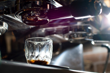 Close-up of making coffee, a coffee machine pours espresso into a glass