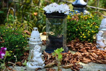 Votive candles, memorial candles light on grave 