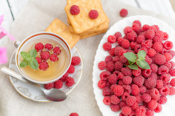 A plate of fresh raspberries tea with raspberries as a remedy for colds in the fall