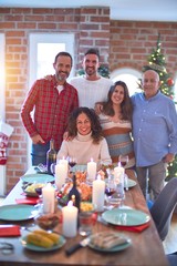 Beautiful family smiling happy and confident. Standing and posing with tree celebrating Christmas at home