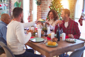 Beautiful family smiling happy and confident. Eating roasted turkey celebrating Christmas at home