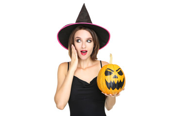 Happy young woman in black costume holding halloween pumpkin on white background