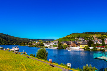 Fototapeta na wymiar View of the Middle Moselle River with cruise ships and Traben - part of the beautiful town of Traben-Trarbach, Germany