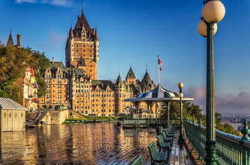 Fototapeta premium Quebec City. PQ, Canada - September 3, 2014: The Terrasse Duferin on a damp summer morning with a pavillion and the Chateau Frontenac in the distance with a blue sky.